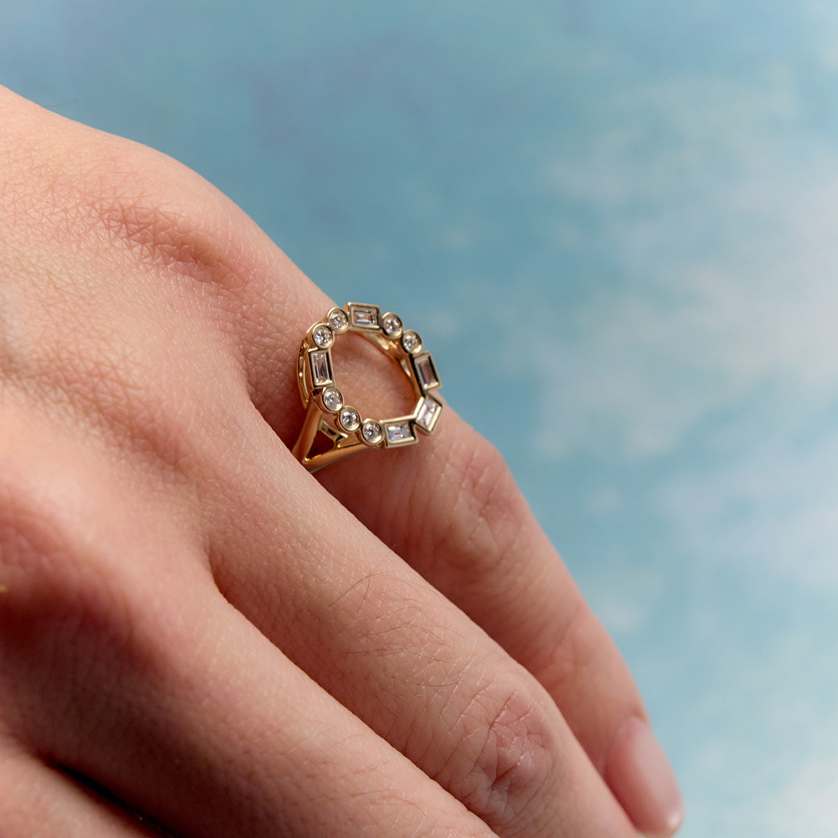Morse Code LOVE pinky ring in 14k yellow gold, oval diamond design, baguette and round diamonds worn on pink ring.
