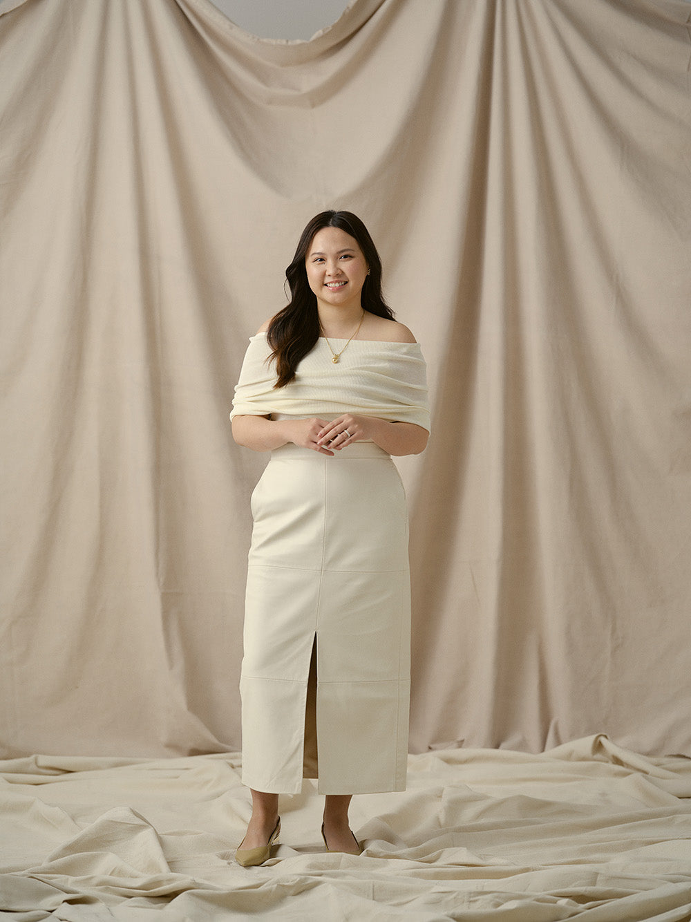 Carin from Faith Jewels team posing on beige backdrop.