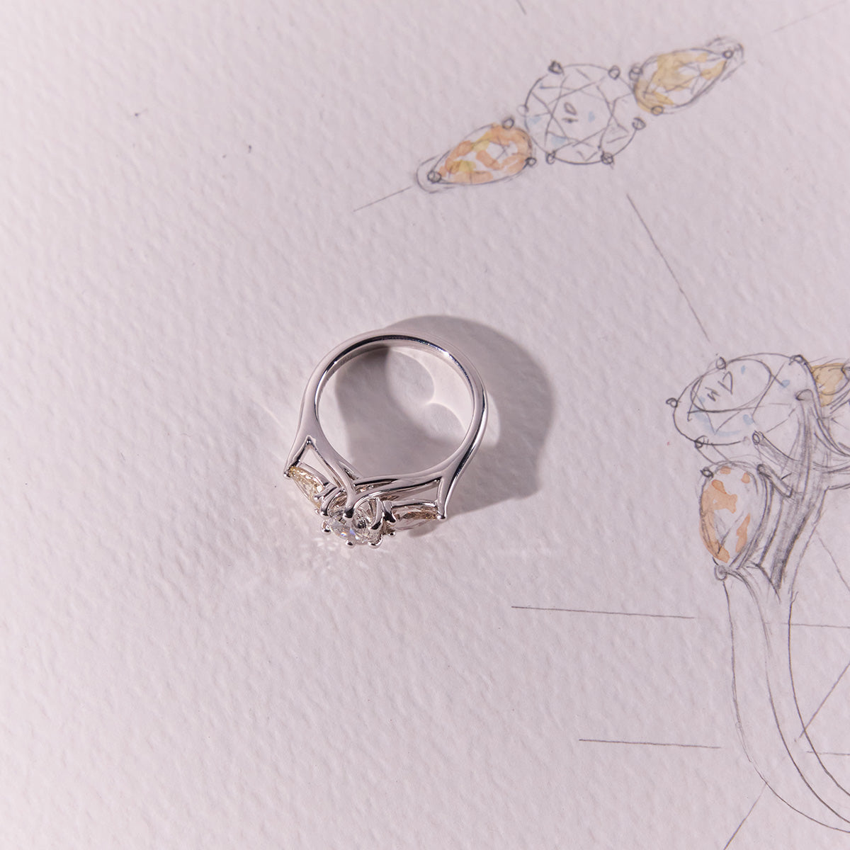 Trilogy Diamond Engagement Ring with three stones on refined band, pear-cut side diamonds, timeless elegant engagement ring design