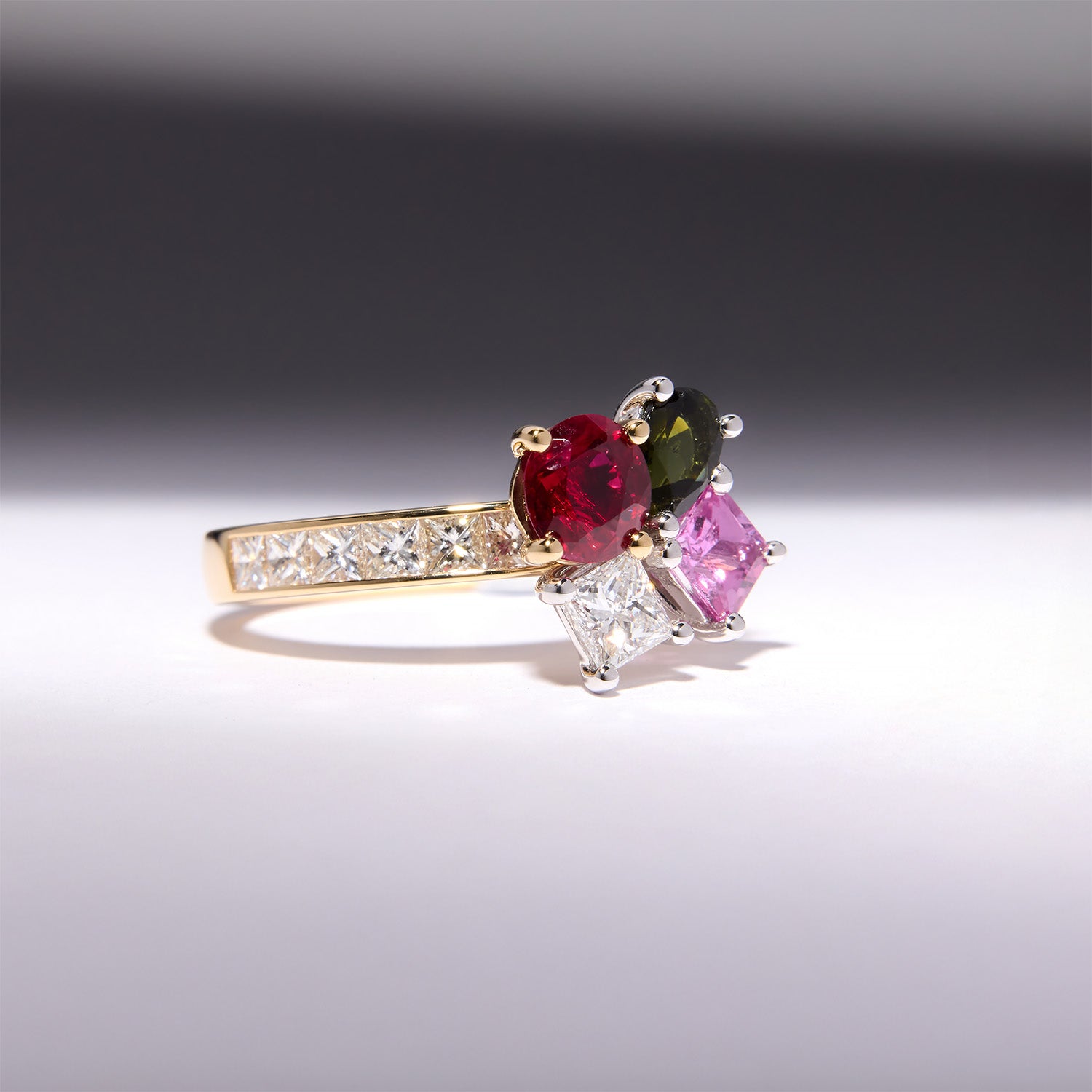Ring with Burmese ruby, pink sapphire, green tourmaline, and diamonds in 18k yellow gold, side view