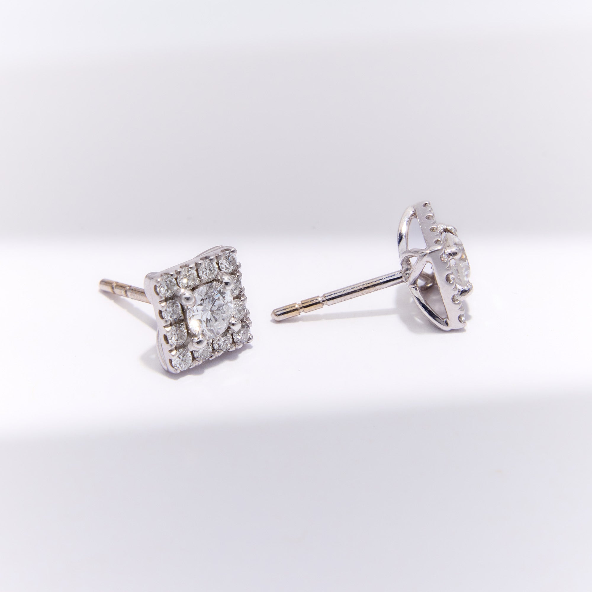 Elegant square diamond stud earrings with halo set in 18k white gold