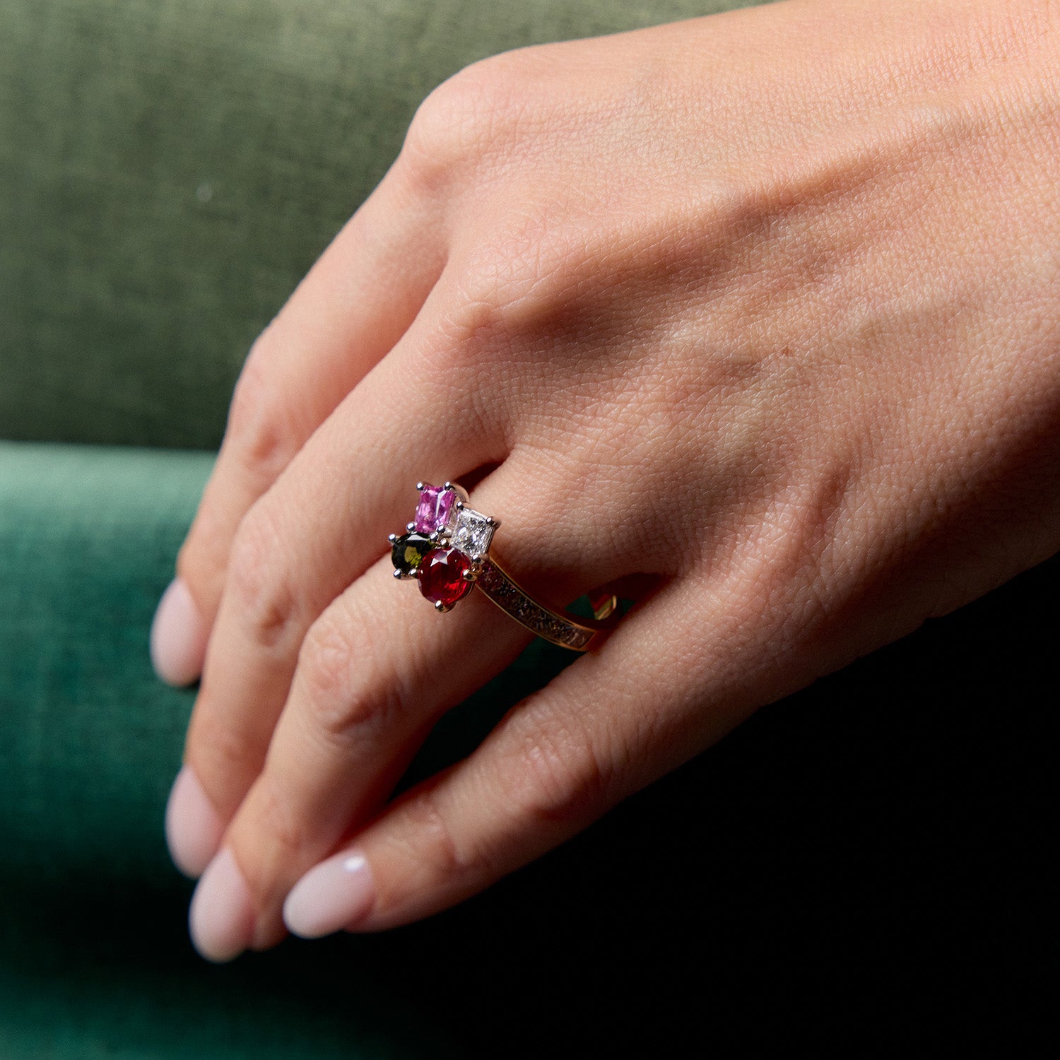 Family Birthstone Bouquet Ring with pink sapphire, green tourmaline, Burmese ruby, and diamonds. Worn on hand model.