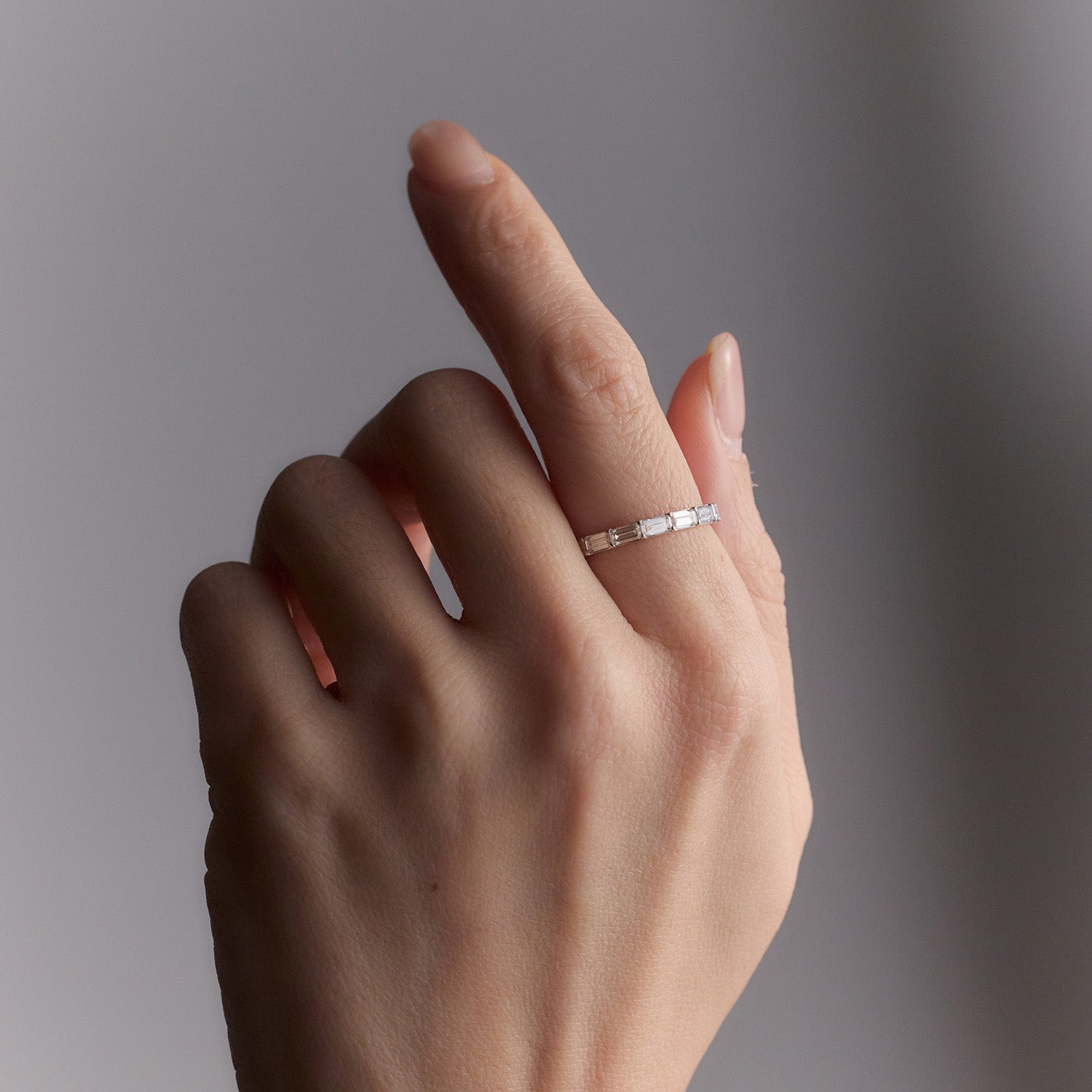 18k white gold Morse code ring featuring diamonds spelling family initials, a modern wedding band, worn on model.