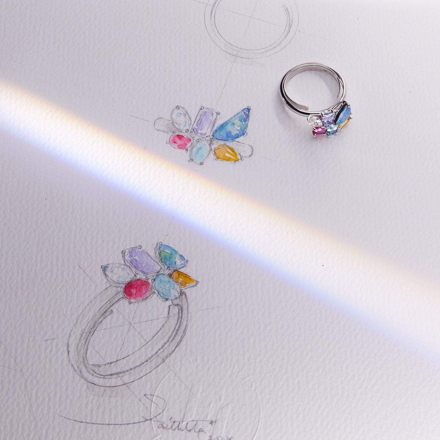 Hazel birthstone white gold band ring featuring aquamarine, diamond, opal, ruby, citrine, and tanzanite arranged in a colourful design, symbolizing family