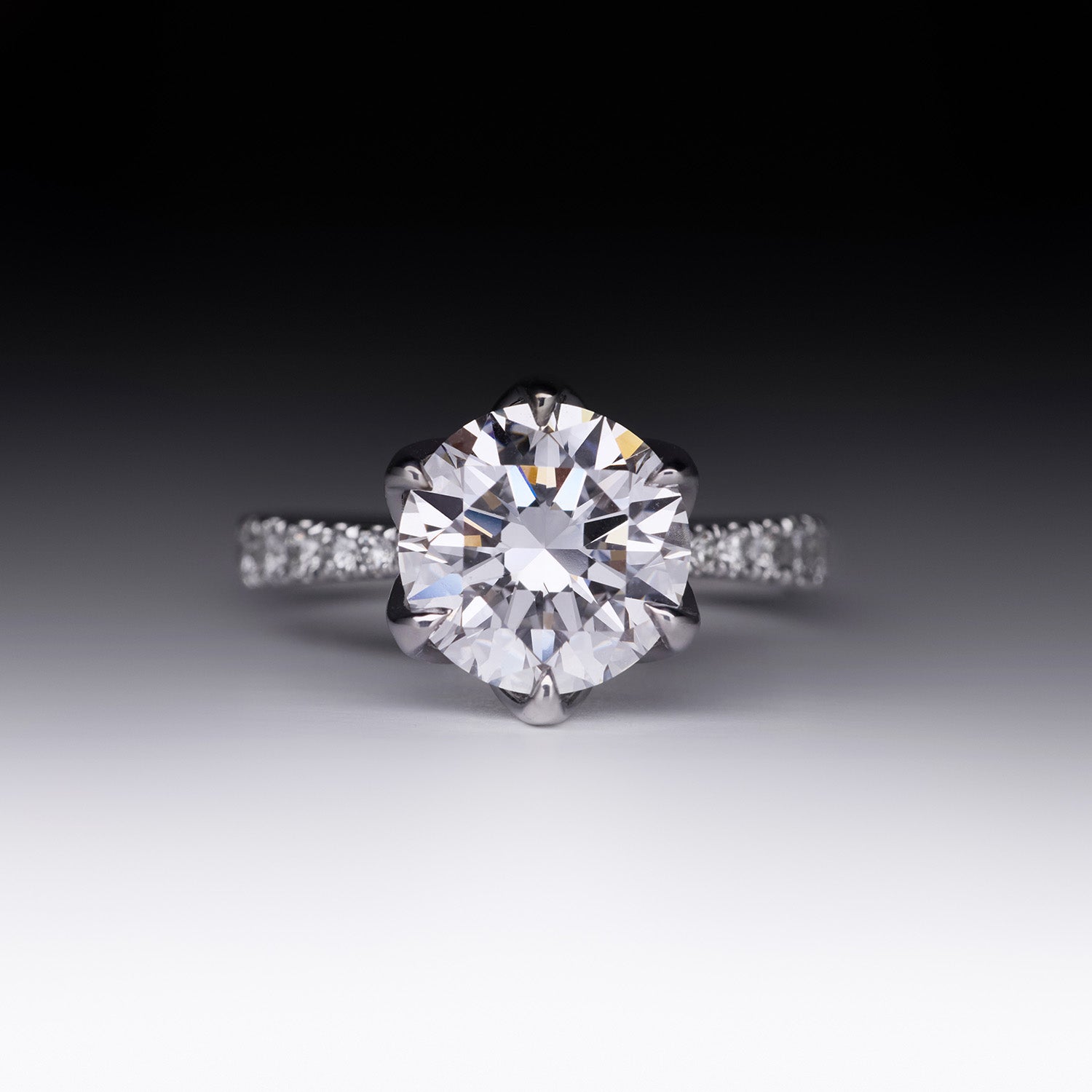 Sylvia diamond engagement ring with round brilliant-cut center stone and pavé band in white gold by Faith Jewels
