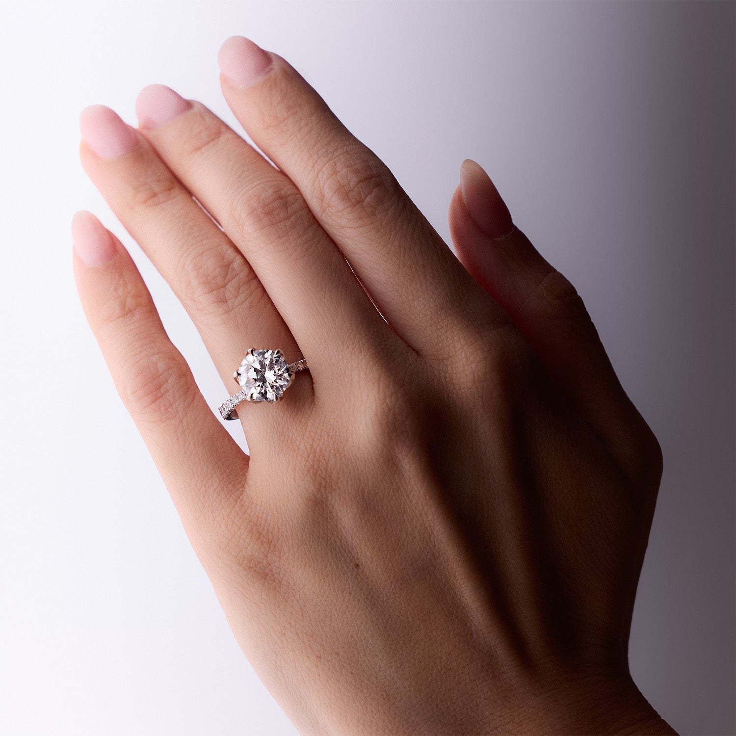 Sylvia diamond engagement ring with round brilliant-cut center stone and pavé band in white gold by Faith Jewels