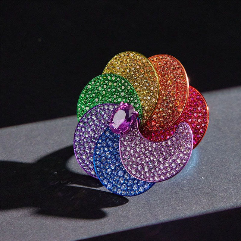 Multicolored gemstone rainbow ring on a dark surface