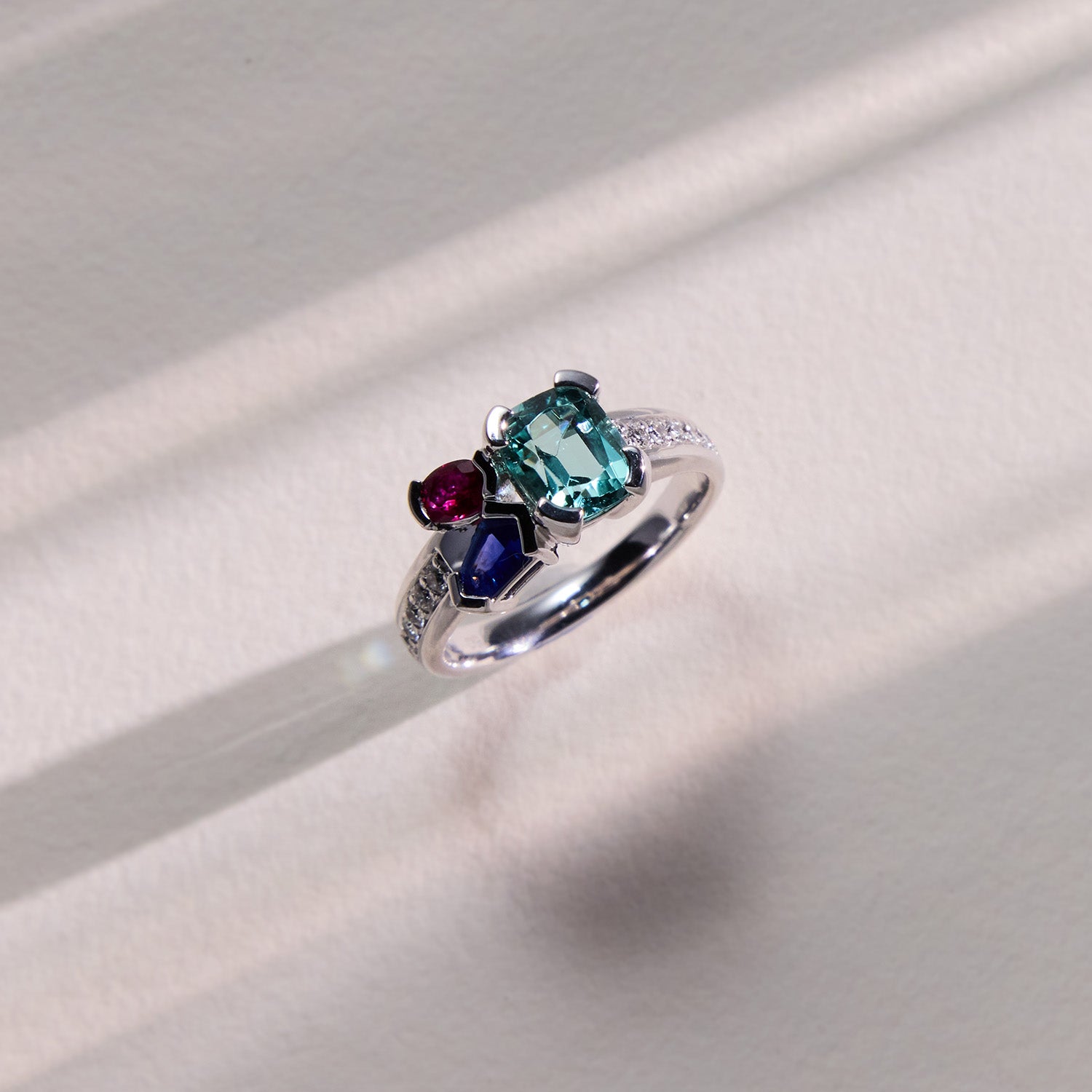 White gold Kelly Bouquet ring featuring ruby, Paraiba tourmaline, blue sapphire, and diamond accents.