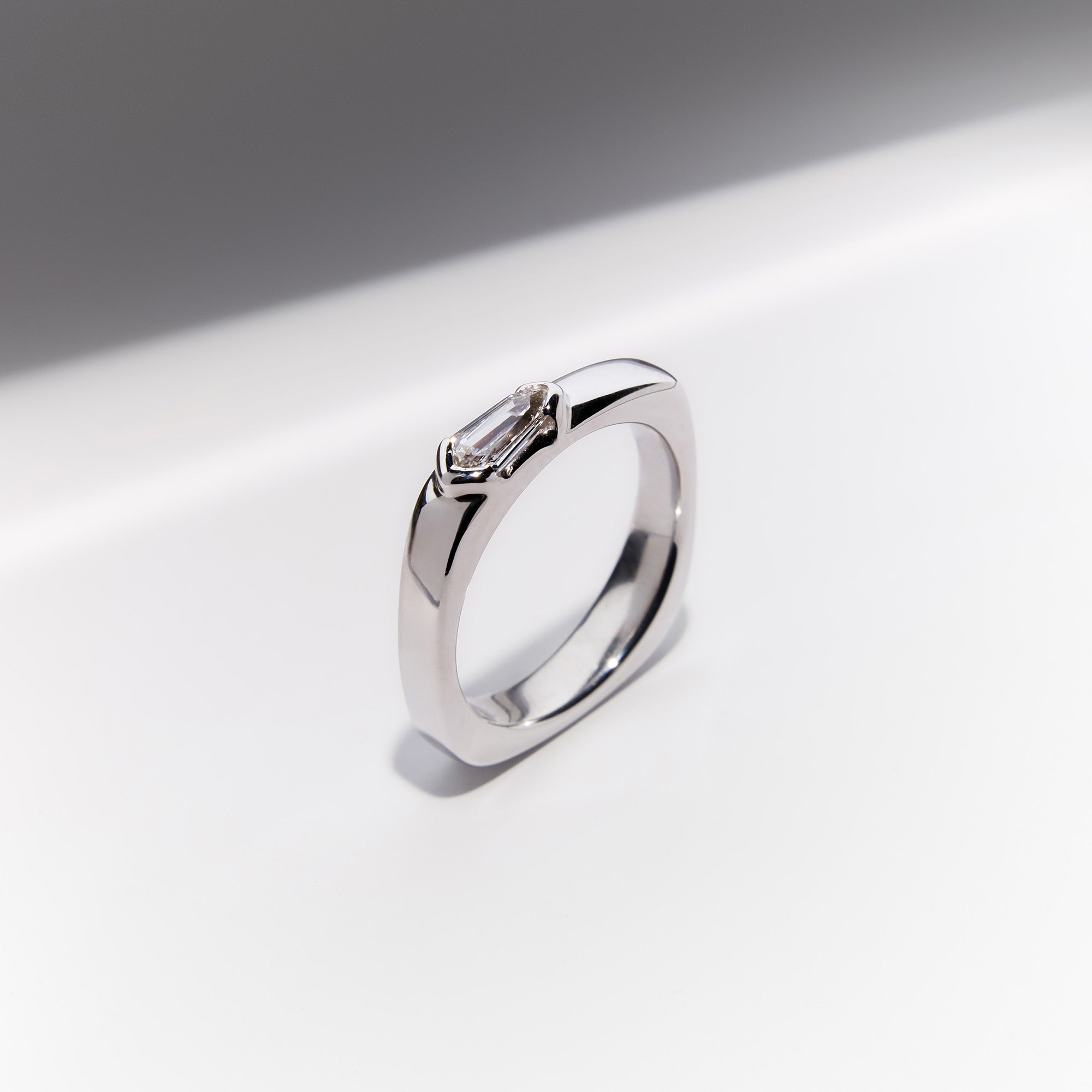 Kite-shaped diamond signet ring in 18k white gold with modern geometric design