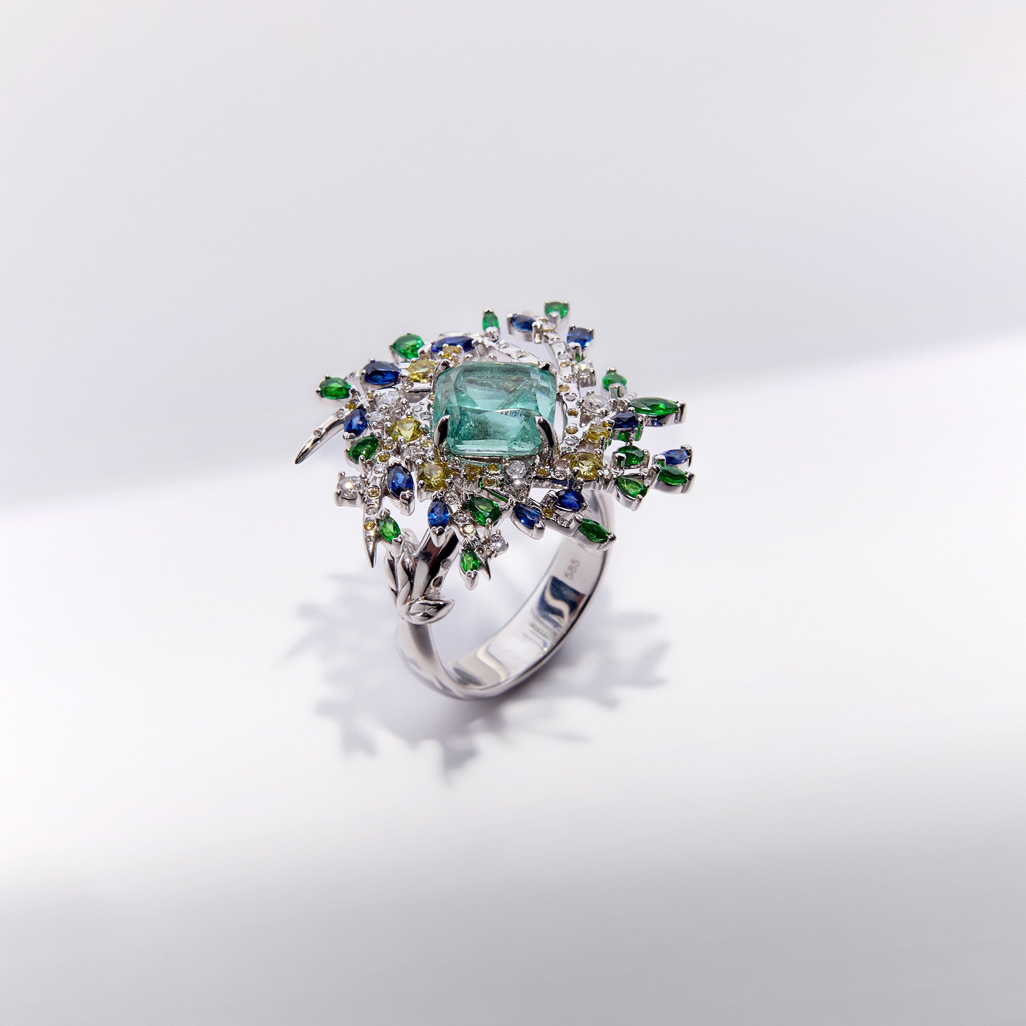 Secret garden-inspired paraiba tourmaline ring with diamonds and natural sapphires