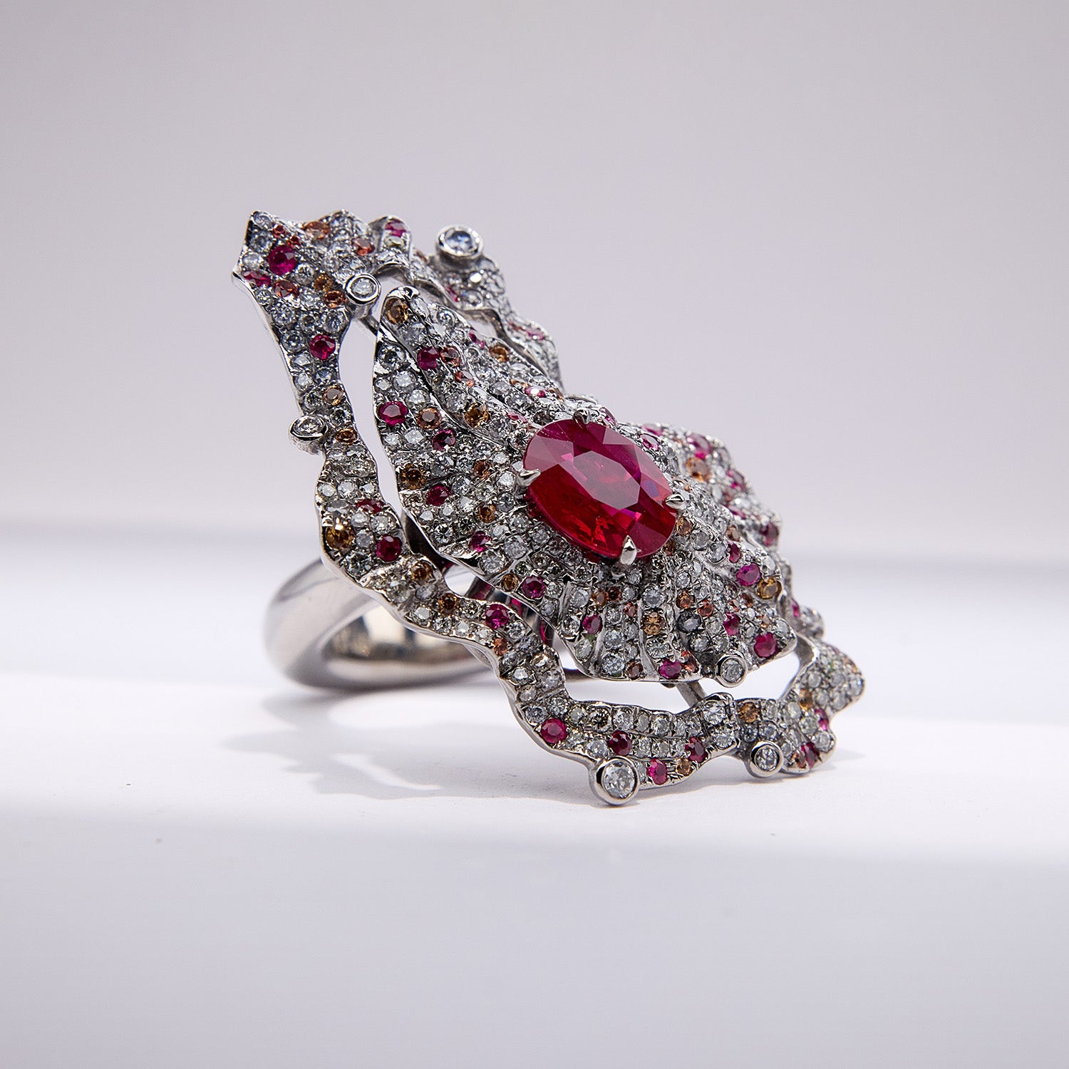The Inferno Ring with Burmese ruby, diamonds, and orange sapphires in grey titanium, fiery and sculptural design