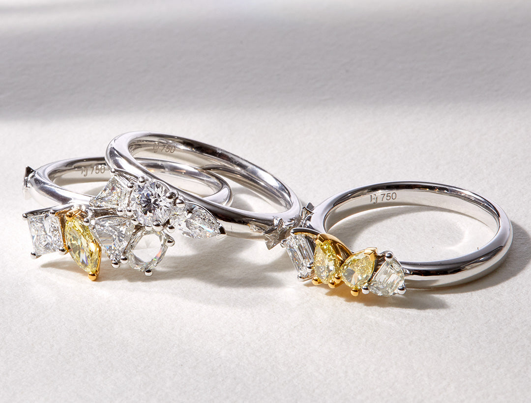 White gold Celestial Stack Ring featuring three interlocking bands set with lozenge, marquise, pear and rare star-shaped diamonds with yellow accents.