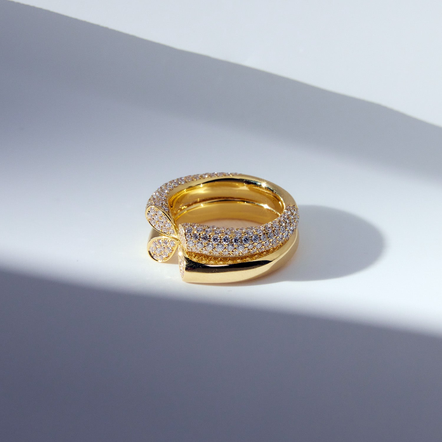 Wide 18k yellow gold diamond ring with heart-shaped lily petal motif from Whispers of Love, stacked on each other.