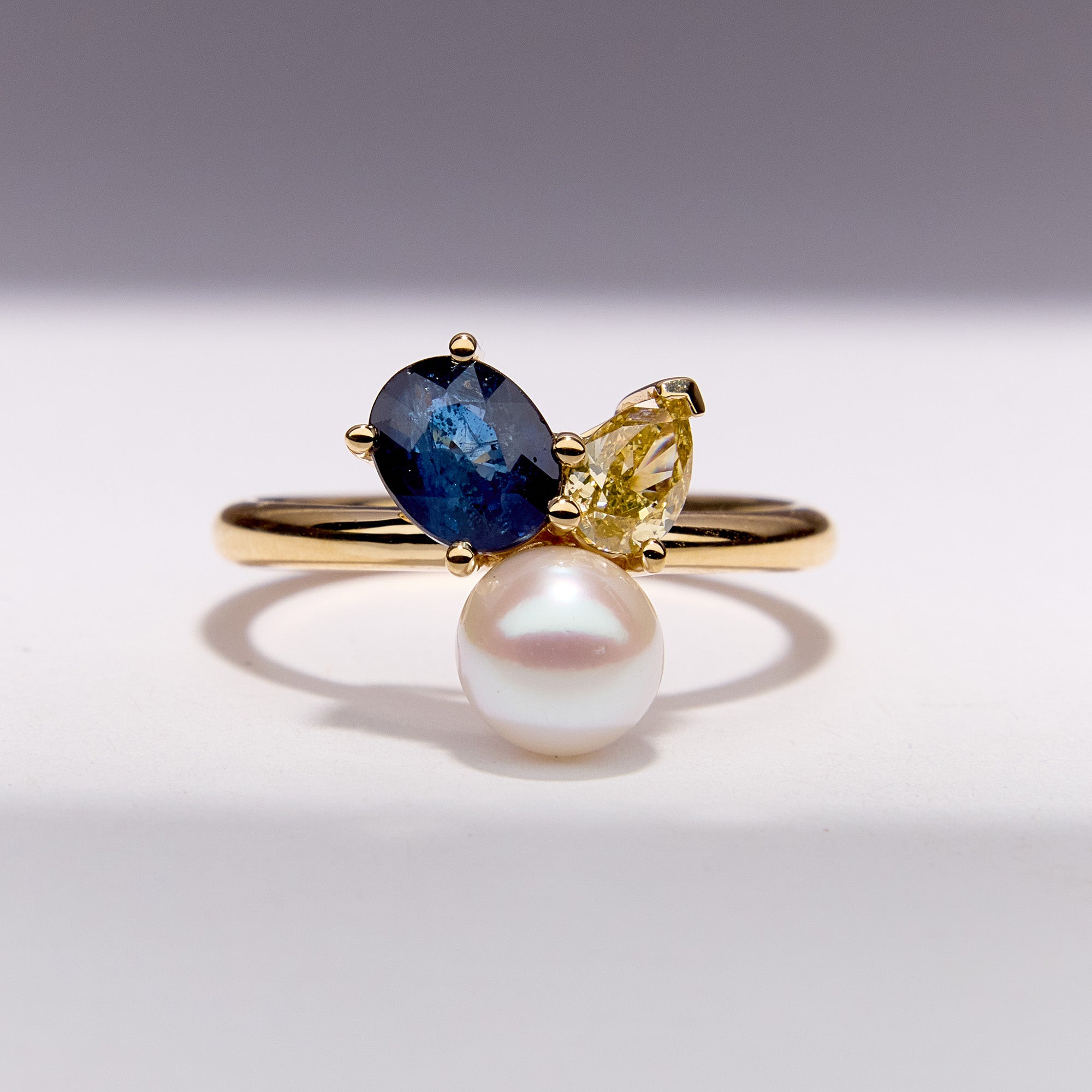 Bespoke Sapphire Pearl Bouquet Ring crafted in 18k yellow gold, featuring blue sapphire, yellow diamond and a luminous pearl.