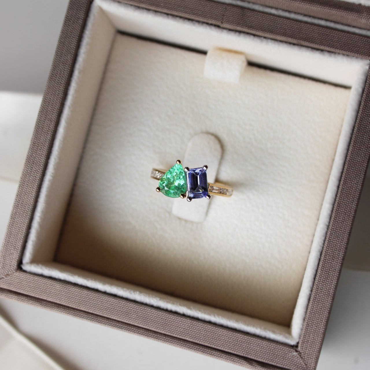 Personalised yellow gold duetto ring with Paraiba tourmaline, amethyst, and diamond Morse code initials A and D.