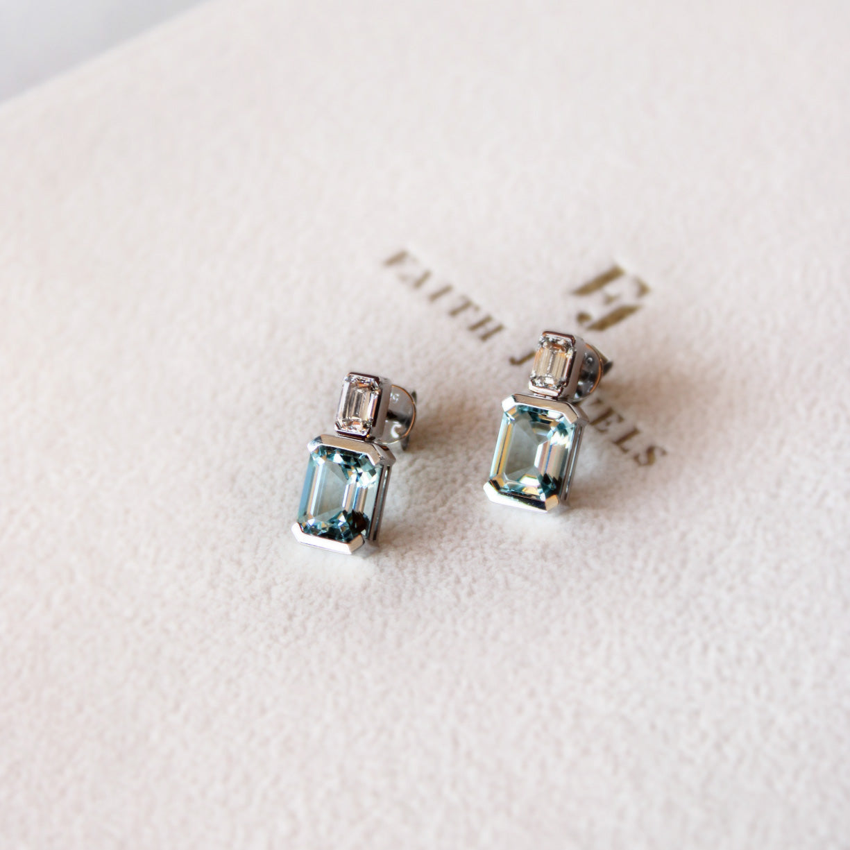 Bespoke aquamarine pendant and earrings set featuring emerald-cut aquamarines and repurposed Tahitian pearls.
