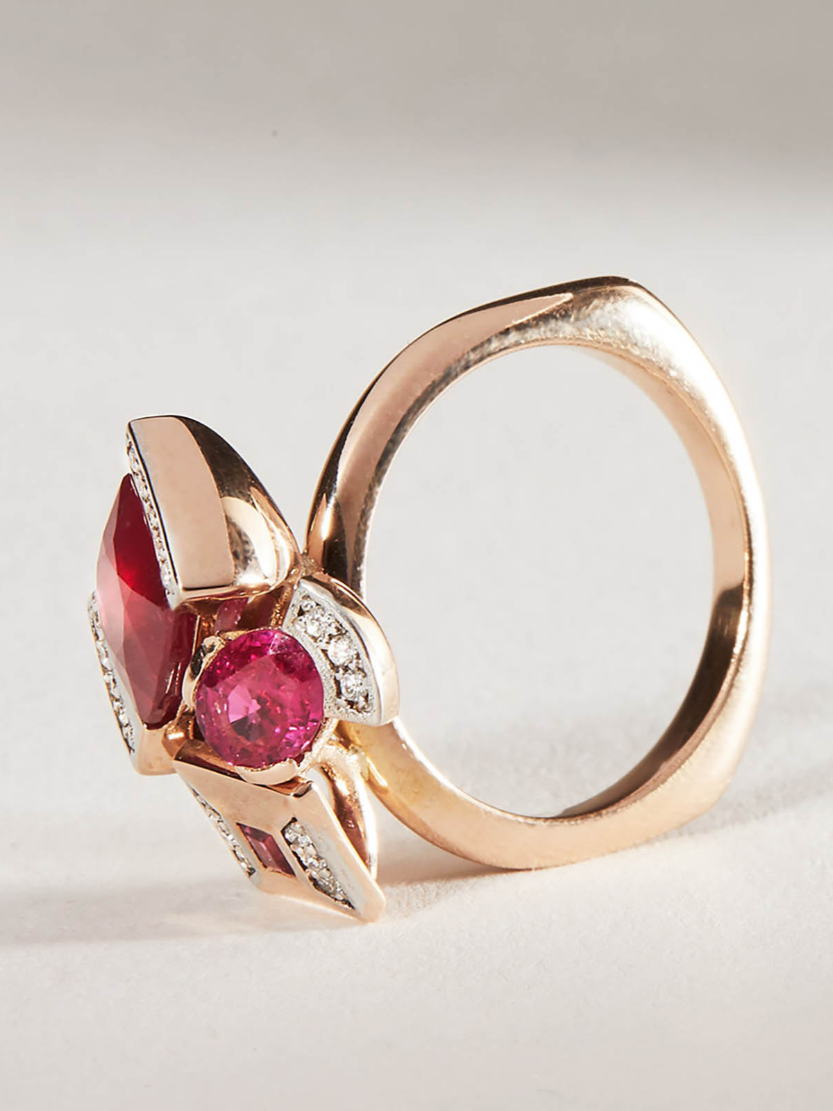 Rose gold ring with red ruby and diamond bouquet design, side view