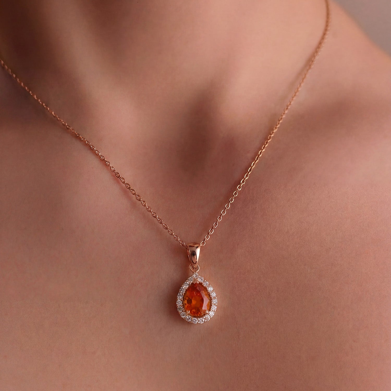 Orange sapphire diamond pendant 3.00ct pear cut, 18k rose gold halo pendant necklace, worn on model.