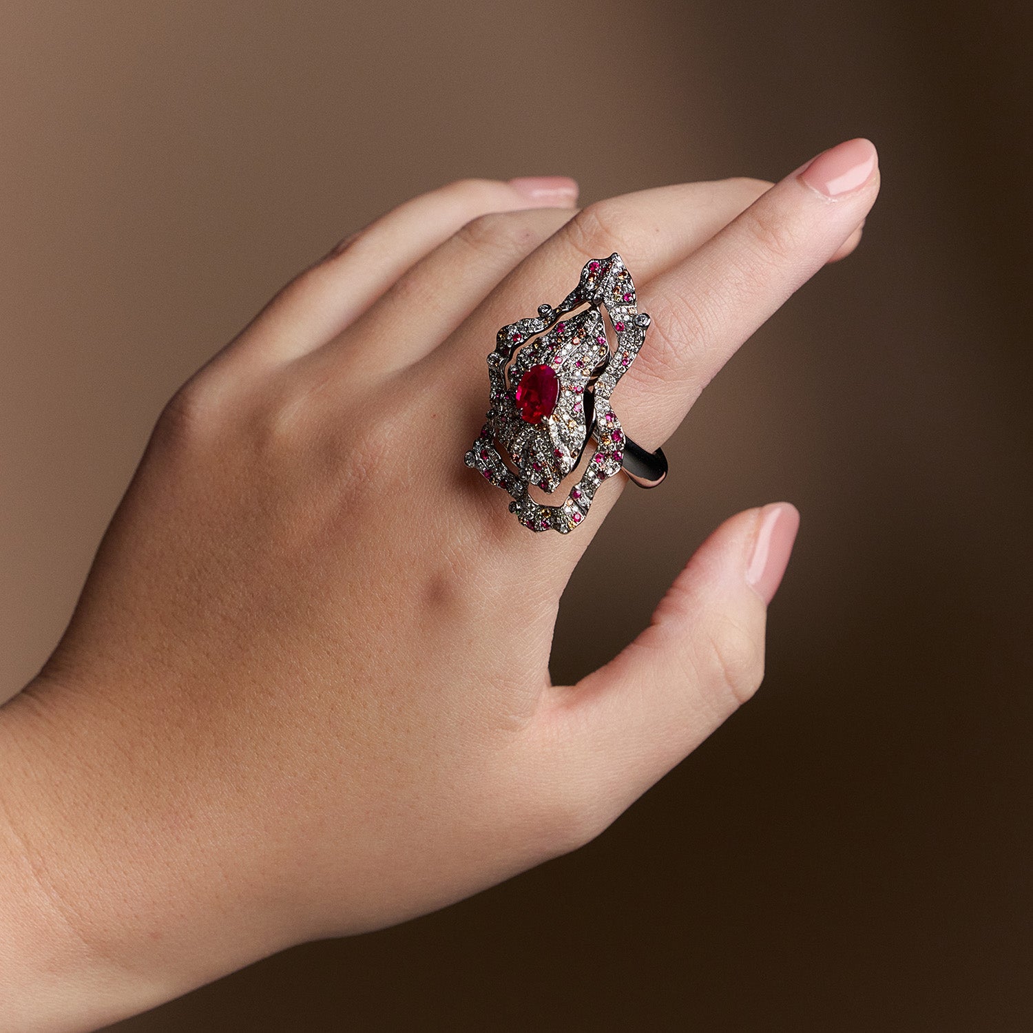 The Inferno Ring with Burmese ruby, diamonds, and orange sapphires in grey titanium, fiery and sculptural design