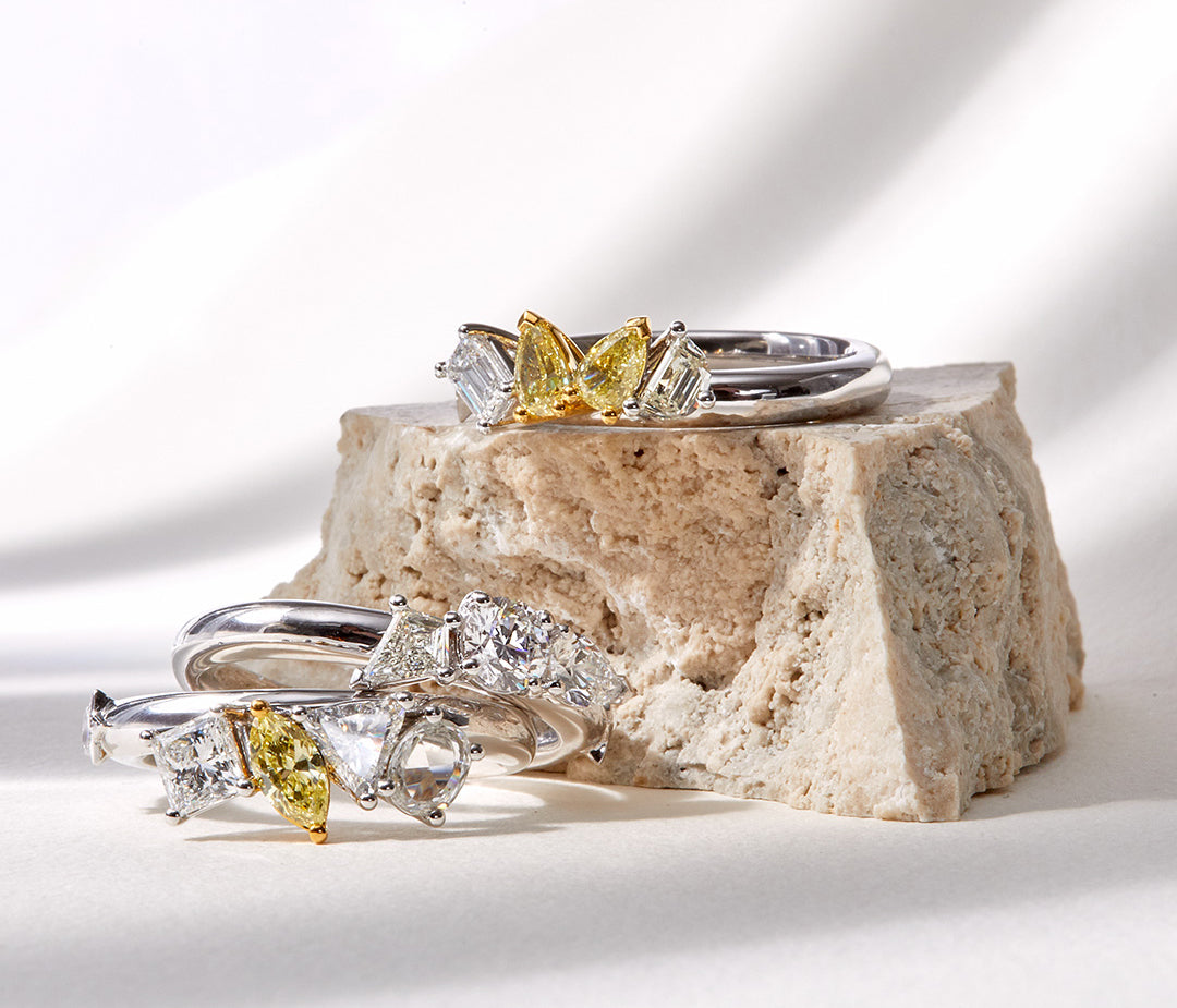 White gold Celestial Stack Ring featuring three interlocking bands set with lozenge, marquise, pear and rare star-shaped diamonds with yellow accents.