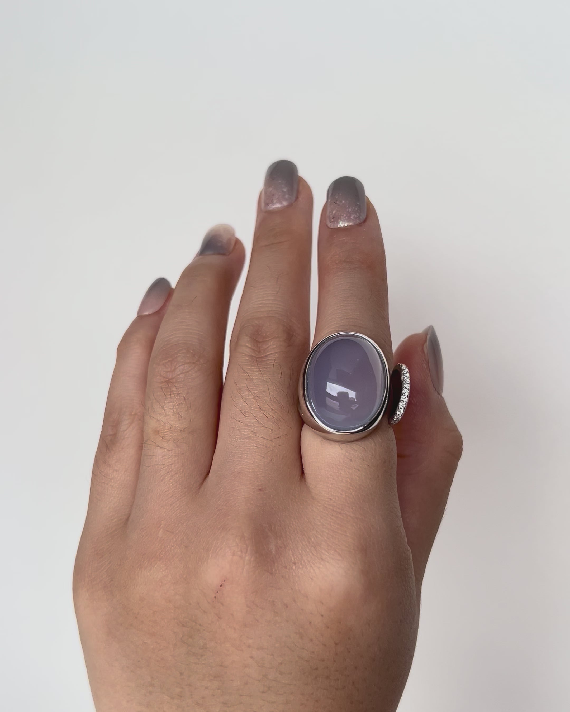 One of a Kind Chalcedony Toi et Moi Ring with 9k white gold and diamond accents, showcasing a luminous blue-lilac cabochon gemstone.