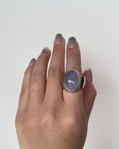 One of a Kind Chalcedony Toi et Moi Ring with 9k white gold and diamond accents, showcasing a luminous blue-lilac cabochon gemstone.