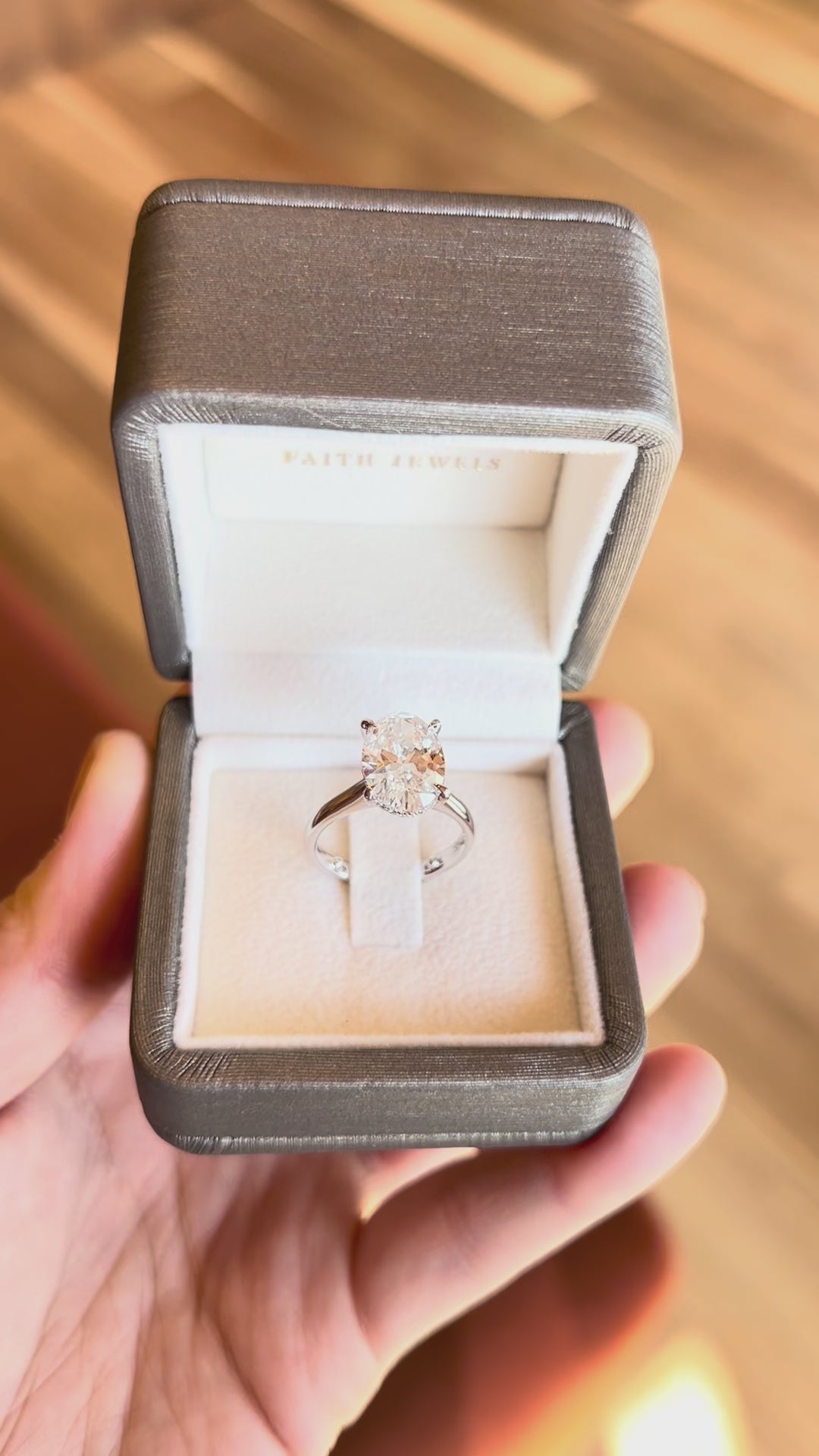 18k white gold engagement ring with 3.72ct oval-cut diamond, elegant band, with hidden halo.