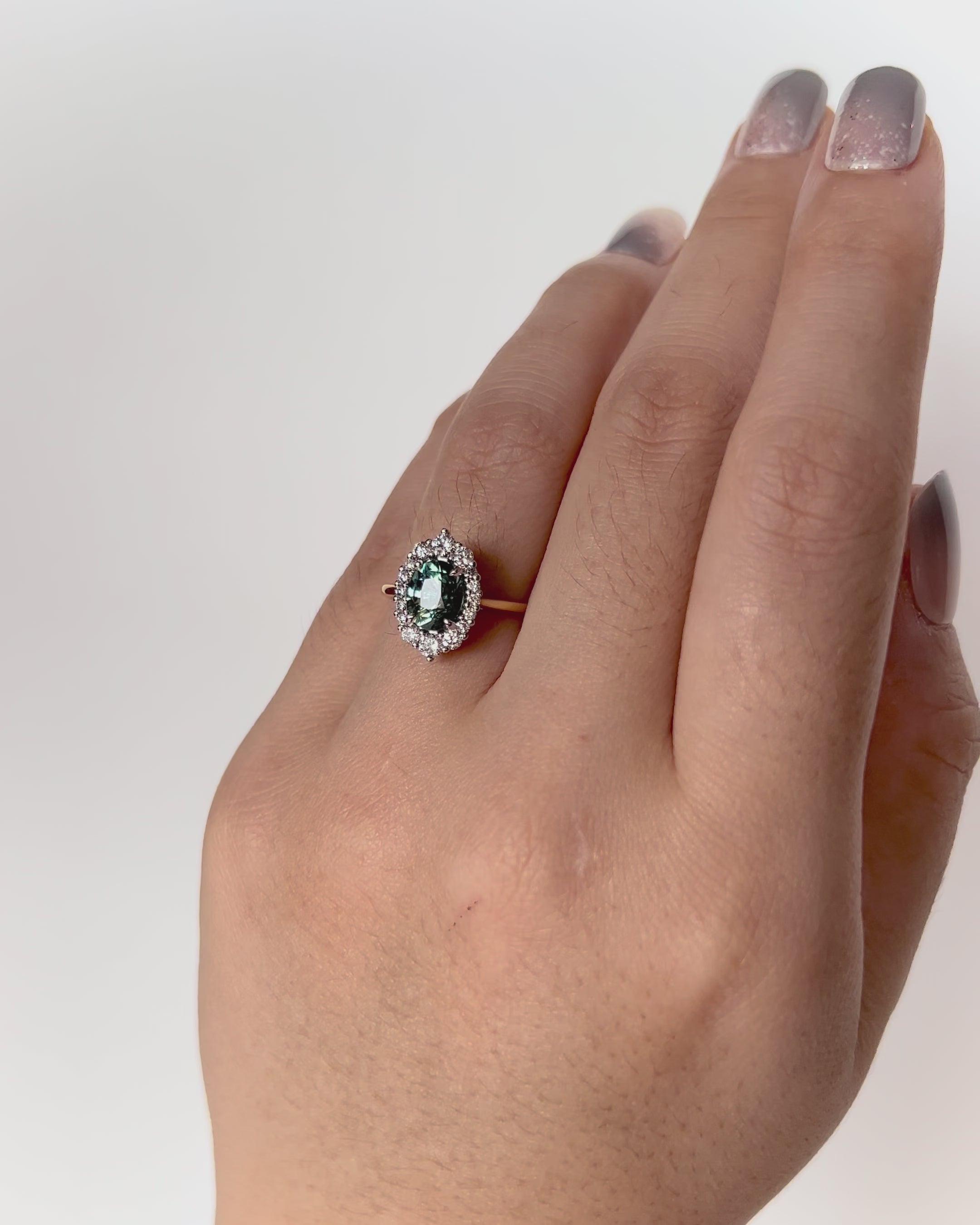 Parti Teal Sapphire Engagement Ring with oval sapphire and diamond halo in two-tone gold